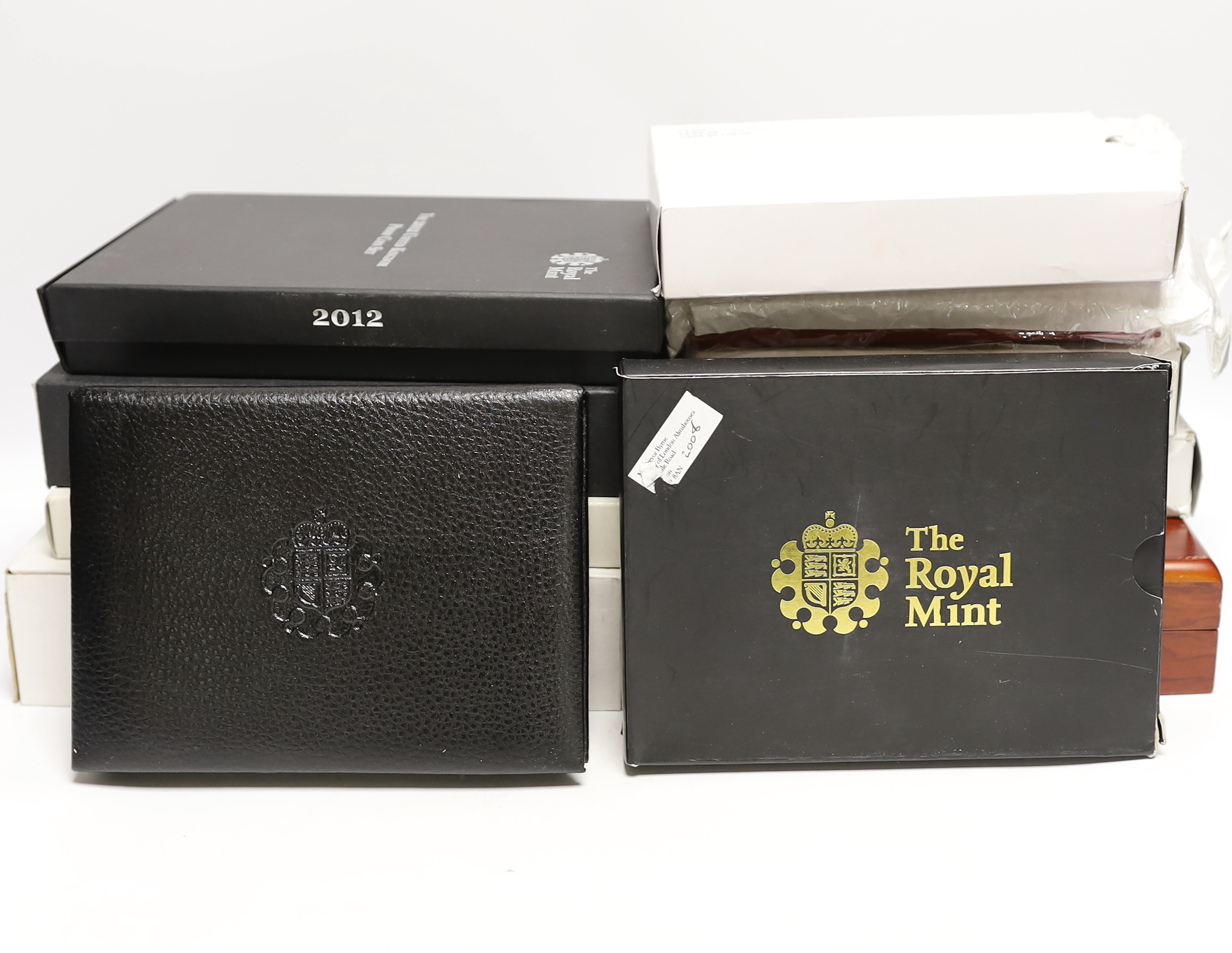 Royal Mint UK QEII proof coin year sets for 2002, 2003, 2005-2008, 2010, 2012 together with two Executive Collections for 2001 & 2004 and a Royal Shield Arms collection 2008, 11 cases